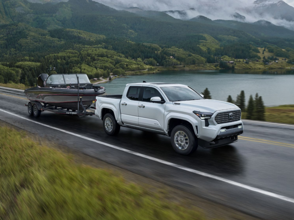 2024 Toyota Tacoma towing a boat on highway